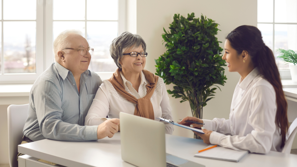 Senior couple receiving consultation with staff member